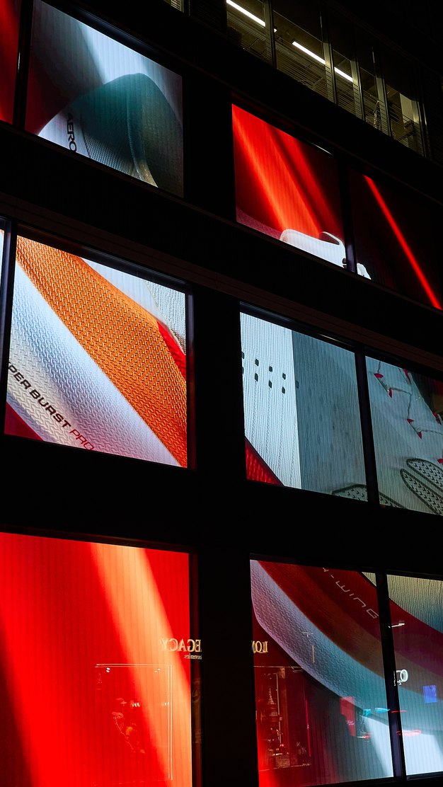 Aero campaign on storefront screens at night