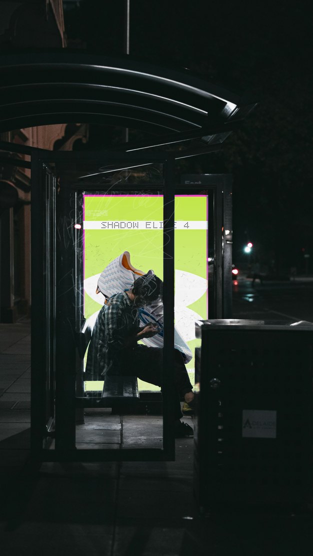 Under Armour poster in a bus shelter at night